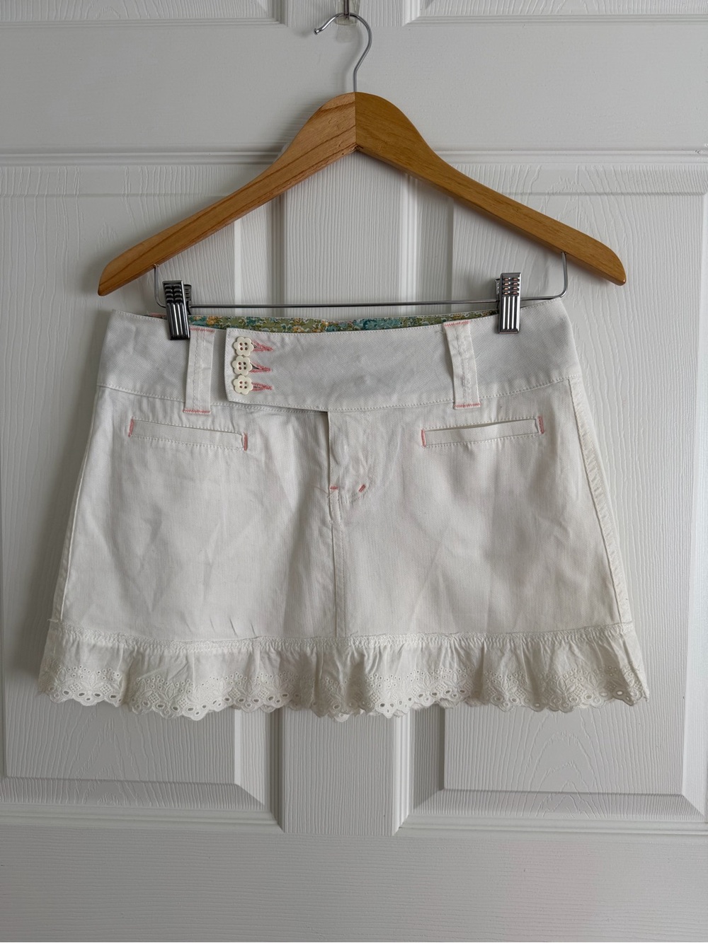 Lola white mini skirt with ruffle hem and floral lining